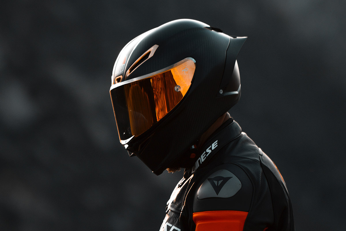 Person wearing a helmet for a motorcycle or trike